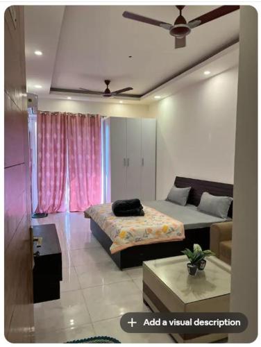 a bedroom with two beds and a couch at Hello Studio in Noida