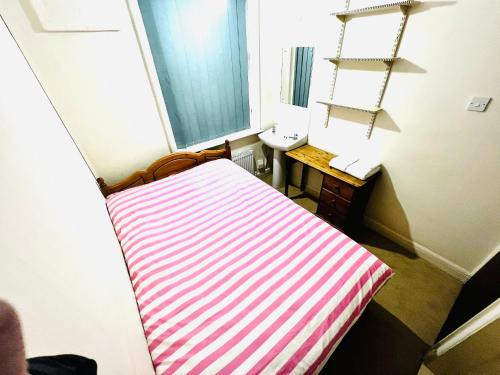 a room with a bed and a sink and a window at Budget Stay In Luton 02 05 in Luton