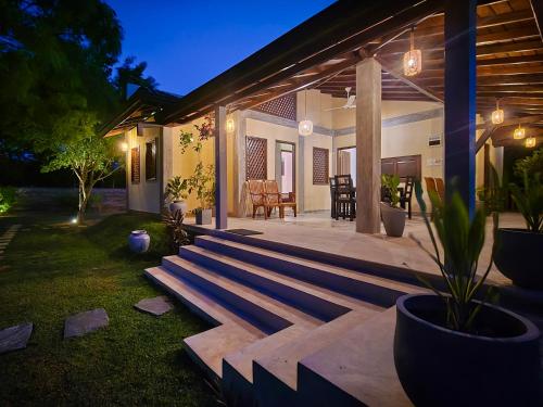 a backyard of a home at night with a patio at Aaryana Lagoon in Tangalle