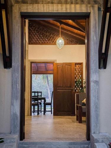 an open door to a dining room with a table at Aaryana Lagoon in Tangalle