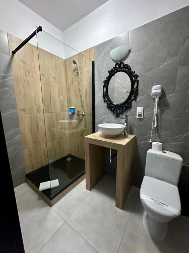 a bathroom with a toilet and a sink and a shower at Villa Stary Kalisz in Kalisz