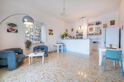a living room with blue chairs and tables at Hotel Britannia in Sorrento