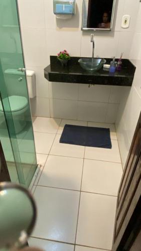 a bathroom with a sink and a toilet and a mirror at Hostel da Dinda in São Luís