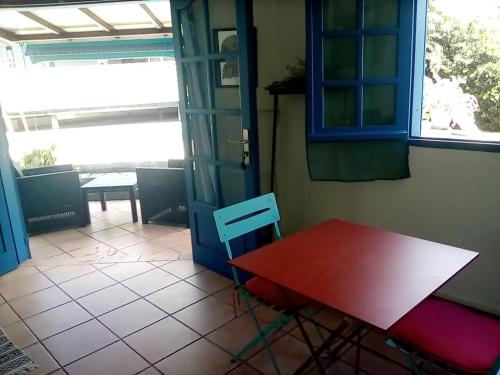a red table and a red chair in a room at Idéal pour séjour professionnel ou touristique in Baie-Mahault