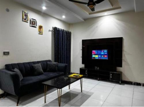 a living room with a couch and a tv at Apartments 