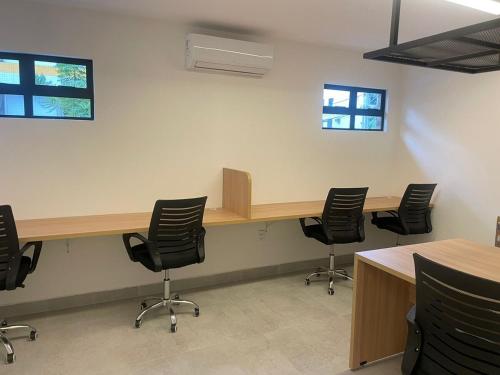 an office with desks and chairs in a room at Flat Novissimo ,100M mar , praia Intermares, acomoda ate 4 pessoas in Cabedelo