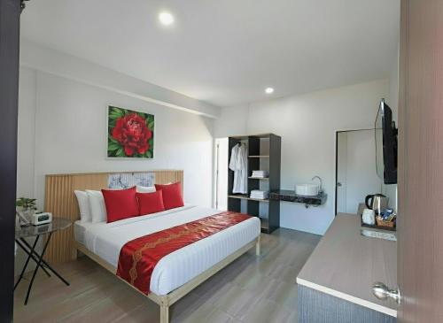 a bedroom with a large bed with red pillows at Ko Lanta Hotels and Working Space in Ko Lanta