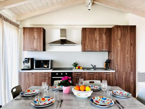 a kitchen with a table with plates of food on it at SOLE DI DIANA LUXURY Apartments in Peschiera del Garda