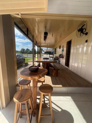 a kitchen with a table and stools in a house at Casa Benedet's in Louro Müller