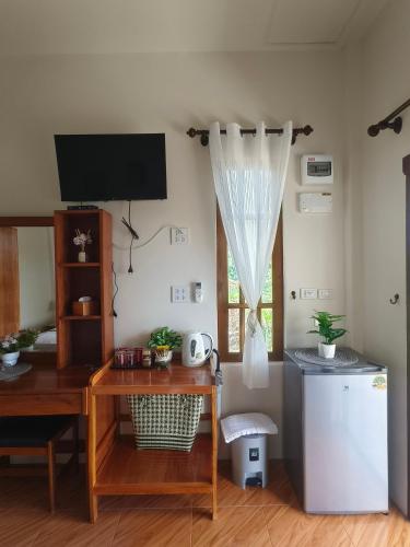a room with a desk and a television and a table at Koh Mook The Home in Ko Muk