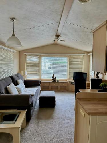 a living room with a couch and a table at Relaxing static stay Holiday park in Northampton