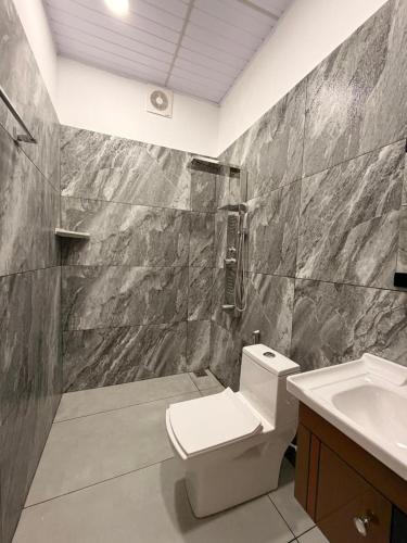 a bathroom with a toilet and a sink at Arvion Holidays in Vagamon