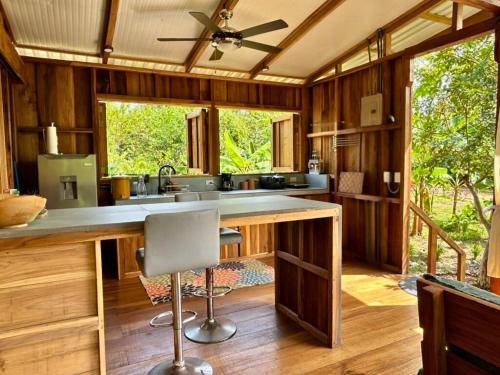 a kitchen with wooden walls and a ceiling fan at Avalon Initiative in Volio