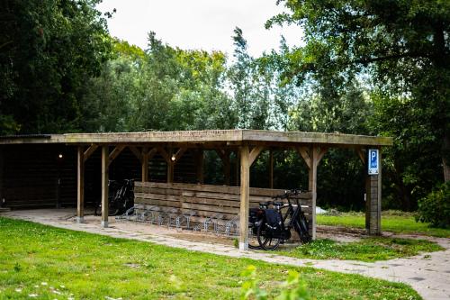 a bike parked under a pavilion in a park at Hotel De Elderschans in Aardenburg