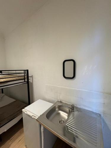 a bathroom with a sink and a bunk bed at Nuitéa Résidence in Marseille