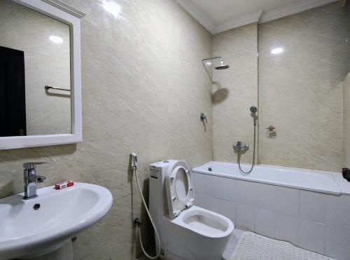 a bathroom with a sink and a toilet and a shower at Panoramic Three Bedrooms Apartment in Addis in Addis Ababa