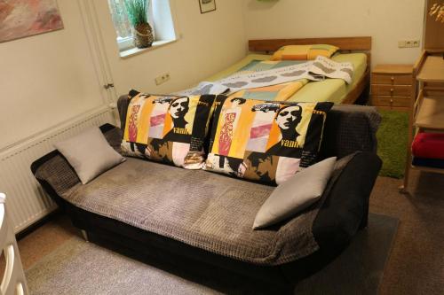 a living room with a couch and a bed at Ferienwohnung am Kocher-Jagst Radweg in Neuenstadt am Kocher