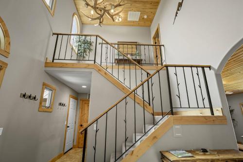 a staircase in a house with wooden railings at 156 Teal Circle in Pagosa Springs