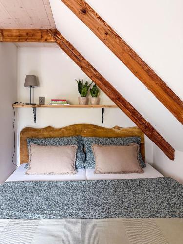 a bedroom with a bed in a attic at Chalupa mezi stezkami in Hejnice