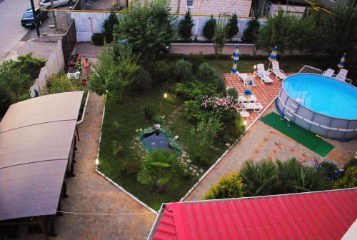 an aerial view of a garden with a swimming pool at Edelveis Guest House in Lazarevskoye