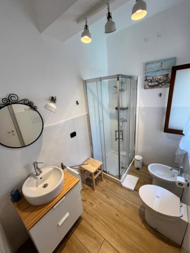 a bathroom with a sink and a glass shower at BedRoom Spiaggia di Ponente in Milazzo