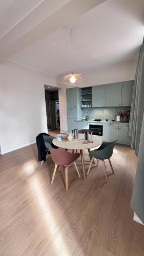 a kitchen and dining room with a table and chairs at Key Inn Appart Hotel Belair in Luxembourg