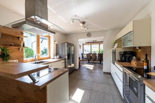 a kitchen with white cabinets and a counter top at Ferienhaus Goldener Anker Unterach am Attersee in Unterach am Attersee