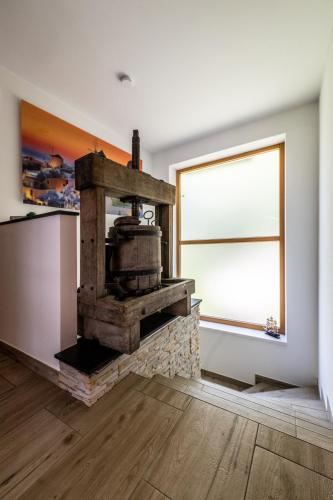 a living room with a stone fireplace with a window at Ferienhaus Goldener Anker Unterach am Attersee in Unterach am Attersee