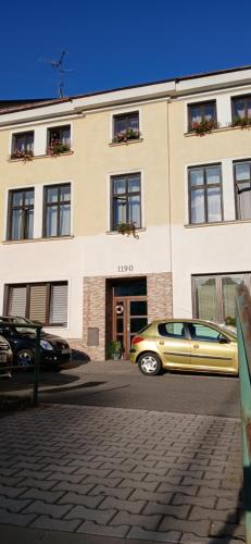 a yellow car parked in front of a building at Apartmán Maršík in Náchod