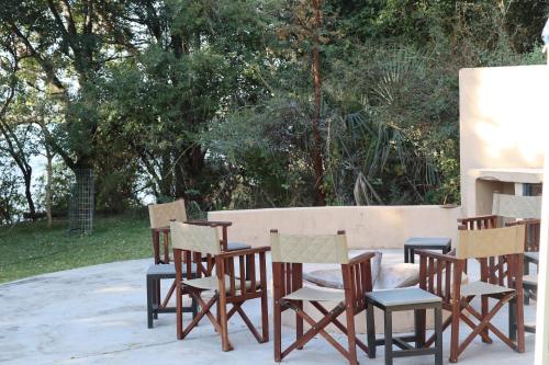 a group of chairs sitting next to a wall at Mongwe Safari Camp 