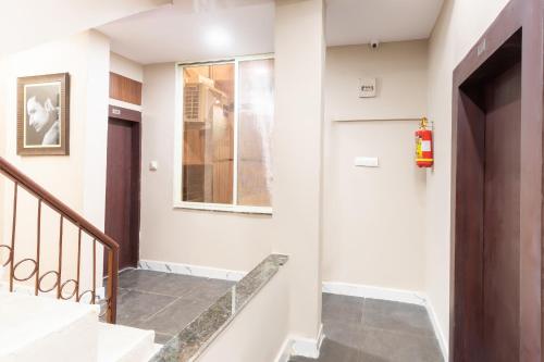 a hallway with stairs and a fire extinguisher at Hotel O Savitri Regency in Bhopal