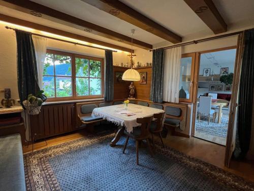 a dining room with a table and a large window at Ferienwohnung Christ in Grinzens