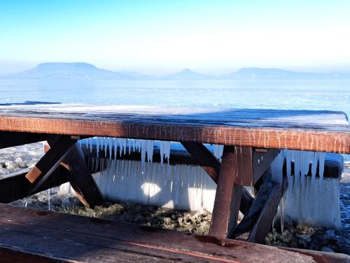 a wooden table with icicles hanging off of it at Berek Vendégház Fonyód in Fonyód