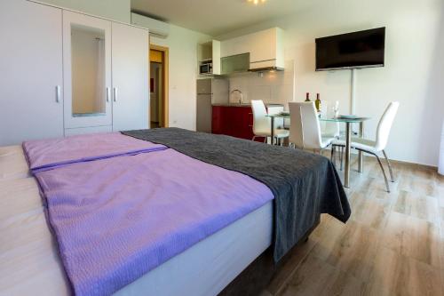 a bedroom with a bed and a table with chairs at Villa Veronika in Omiš