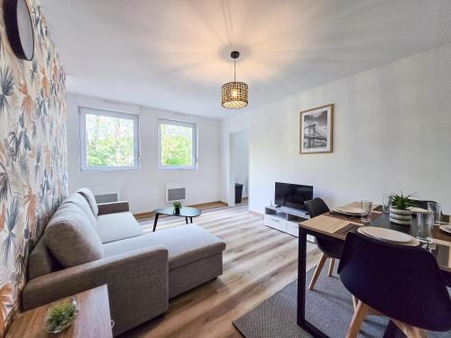 a living room with a couch and a table at Carl'Apartment4 Professionnel Famille WIFI parking in Carling