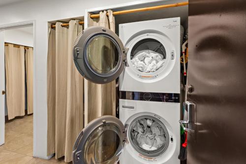 two washing machines sitting next to a refrigerator at Maui Eldorado Condo G203 in Kaanapali