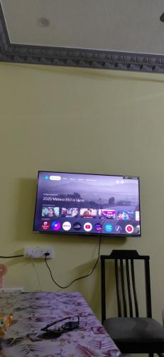 a flat screen tv hanging on a wall at VILLA DE VALENTIN home stay in Puducherry