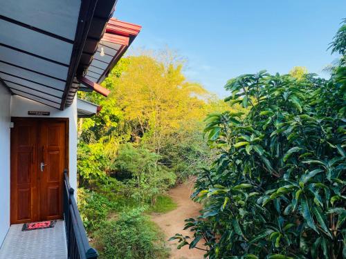 a room with a door and a dirt road at Ritigala Hideaway in Habarana