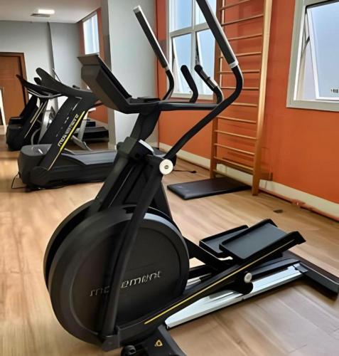 a gym with several exercise bikes in a room at Flat em Alphaville Hotel in Barueri