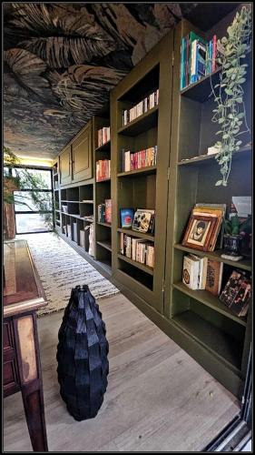 a room with bookshelves and a tire on the floor at L'Eden, villa d'exception entre océan & forêt in Saint-Paul