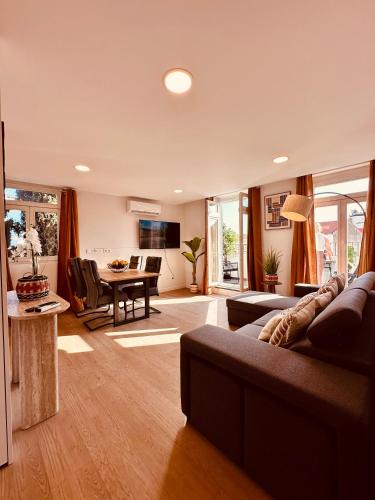 a living room with a couch and a table at Living Funchal Executive in Funchal