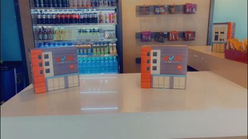 a store with a aisle with bottles of soda at Avid Hotel in Macon