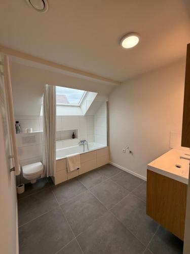 a bathroom with a sink and a bath tub at The Gallery Saint-Gilles in Brussels