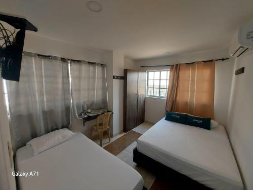 Ένα ή περισσότερα κρεβάτια σε δωμάτιο στο Hotel Villa Marta Cartagena