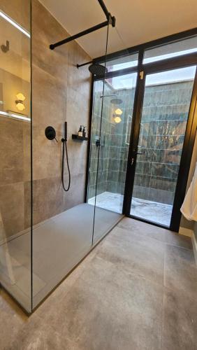 a shower with a glass door in a bathroom at Casa Candeleda Alojamiento Boutique in Candeleda