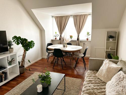 a living room with a table and a couch at Deluxe Apartment on the Main Street with Free Parking & Late Checkout in Herning