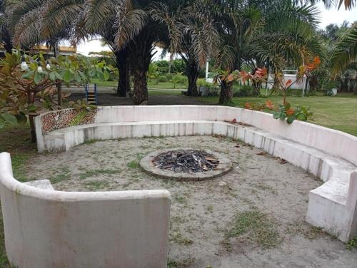 a fire pit in a yard with palm trees at Cojimies Suite in Cojimíes