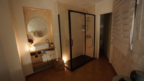 a bathroom with a shower and a mirror at El rinconcito in Benaocaz