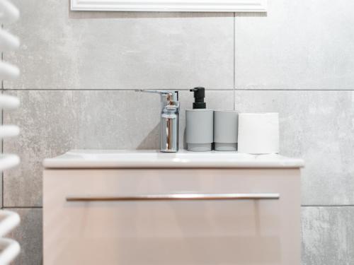 a bathroom sink with a faucet and towels on it at Drevenička v Ďurčinej - Júlia in Ďurčiná