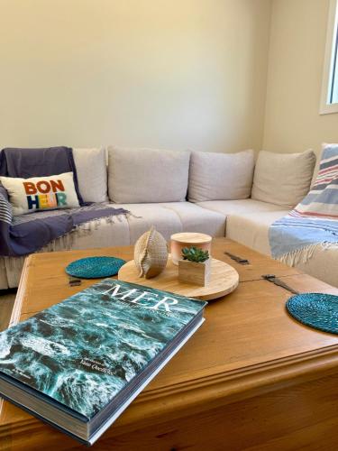 a living room with a couch and a coffee table at Le Clos Es Rio in Plourhan